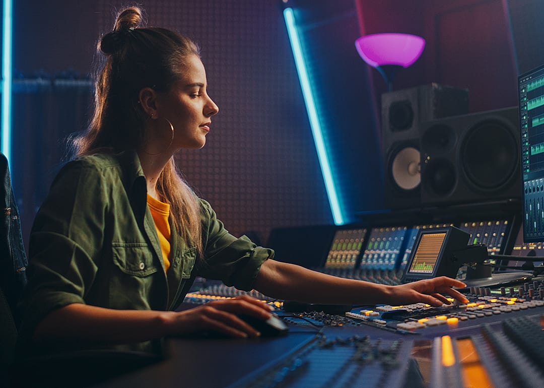 Sound technician working in recording studio.