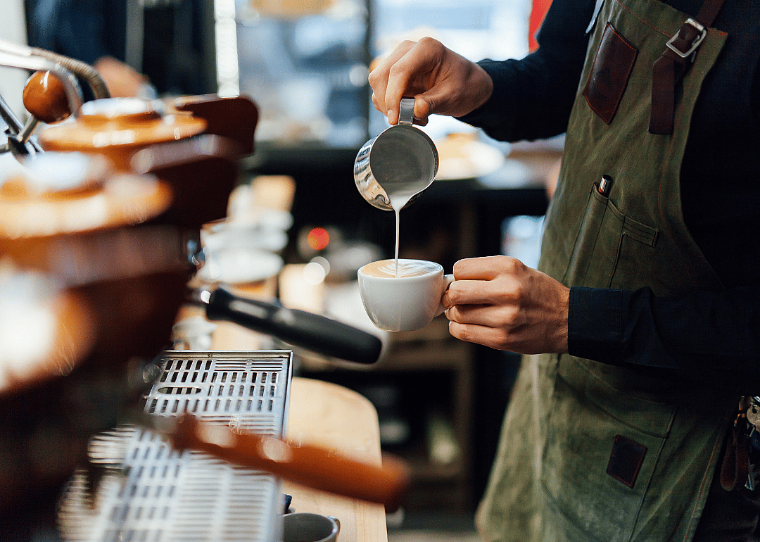 Barista preparing latte.