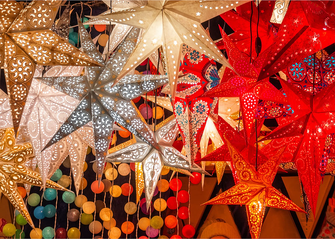 White and red star shaped lanterns hand from a ceiling. 