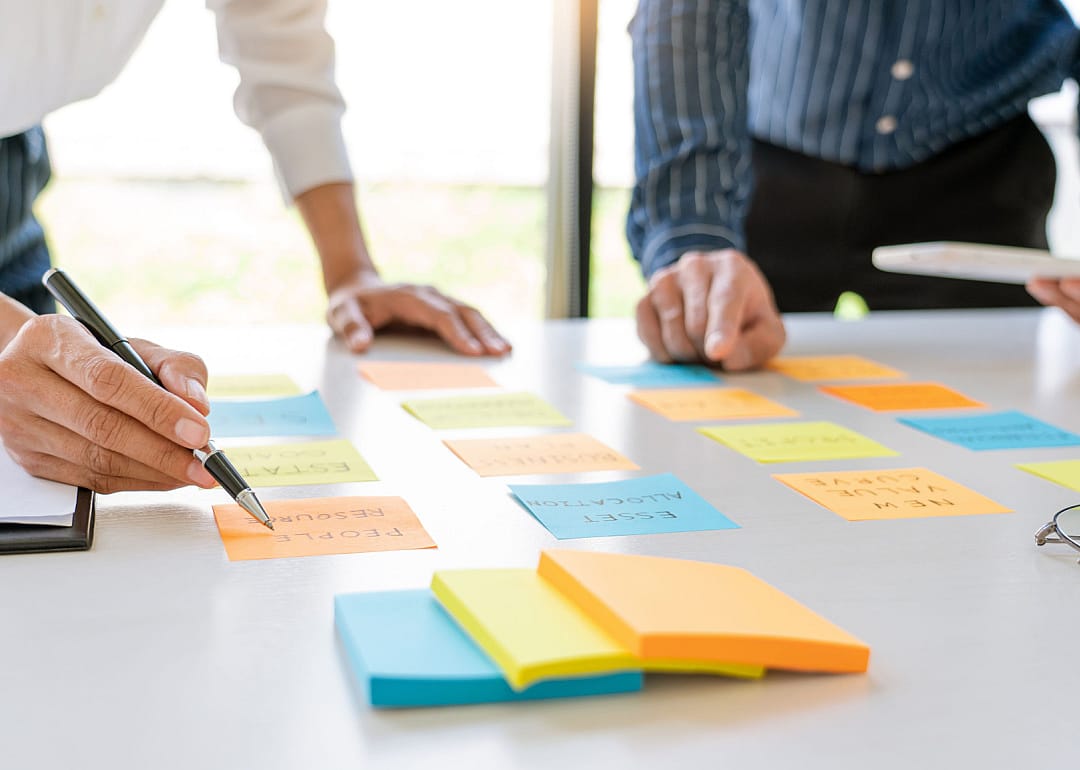 Professionals using writing on colorful sticky notes