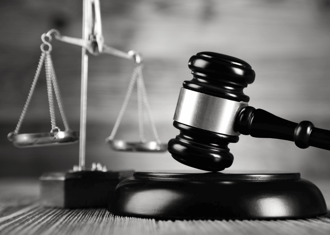 Judge’s gavel and scales on desk.