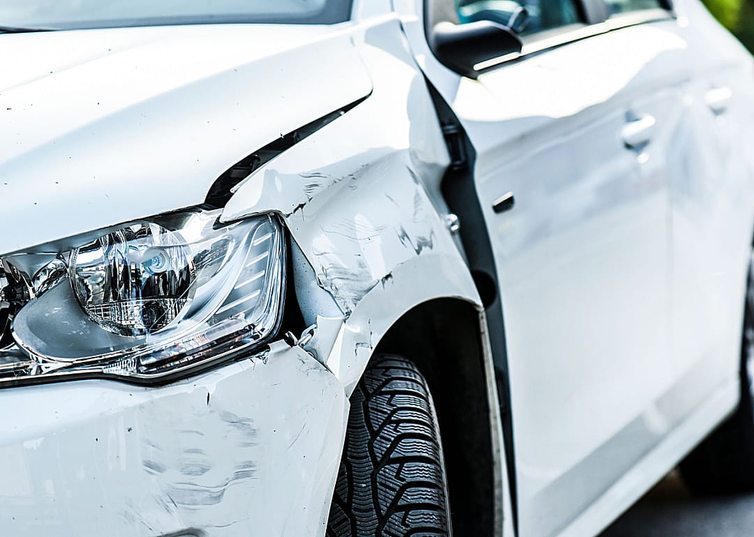 Close-up view of damage to a vehicle after a crash.
