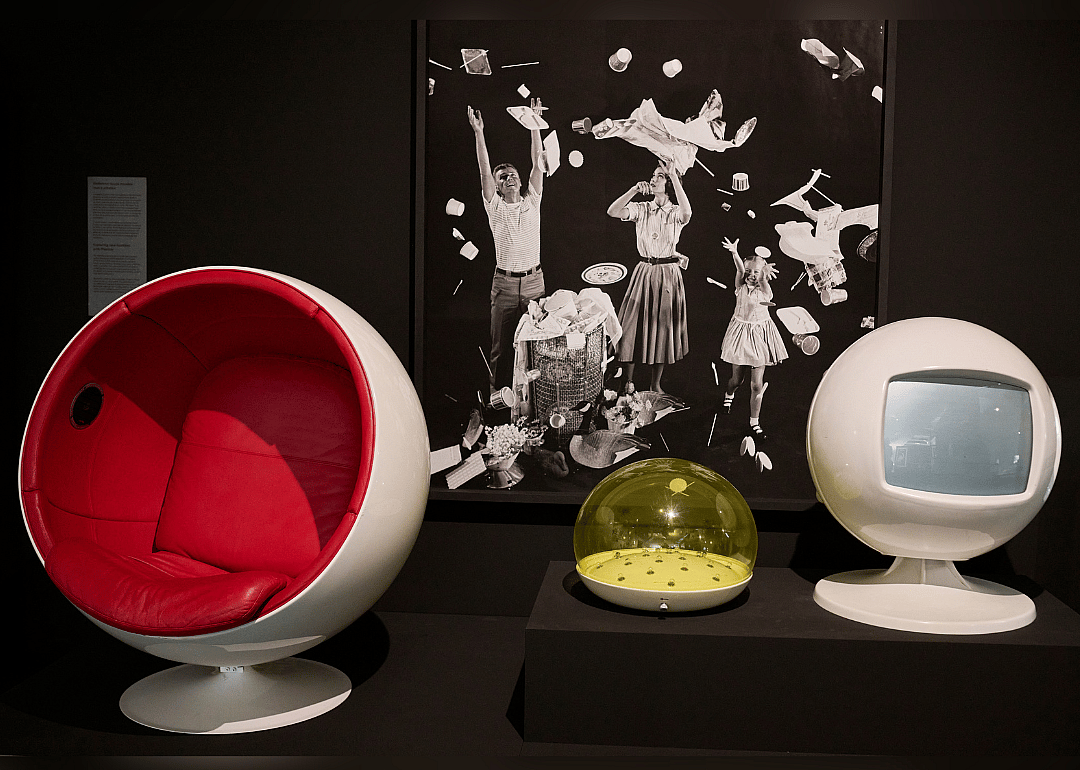 Ball chair and moon lamp displayed in a museum exhibition.