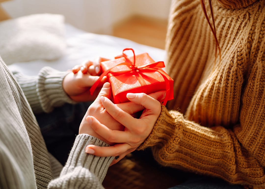 Close-up view on couple exchanging gifts.