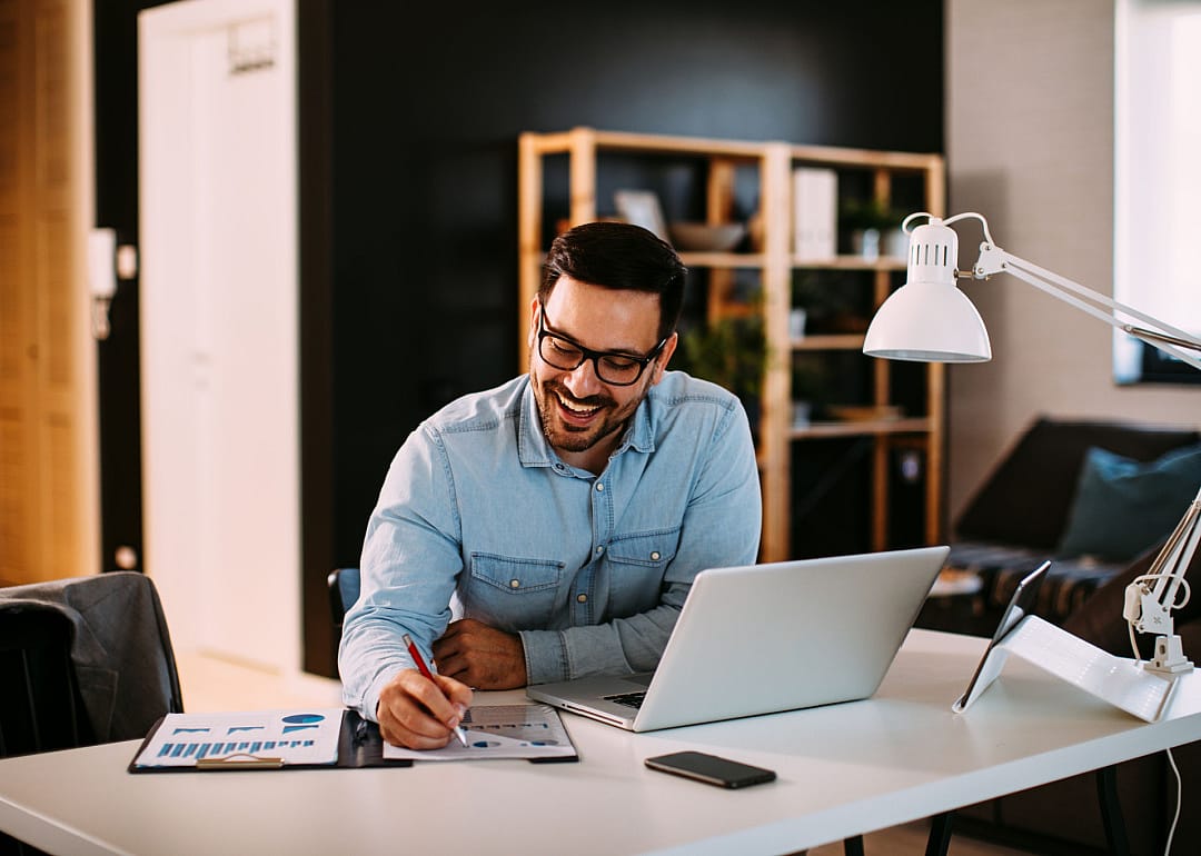Professional working in home office on financial reports.