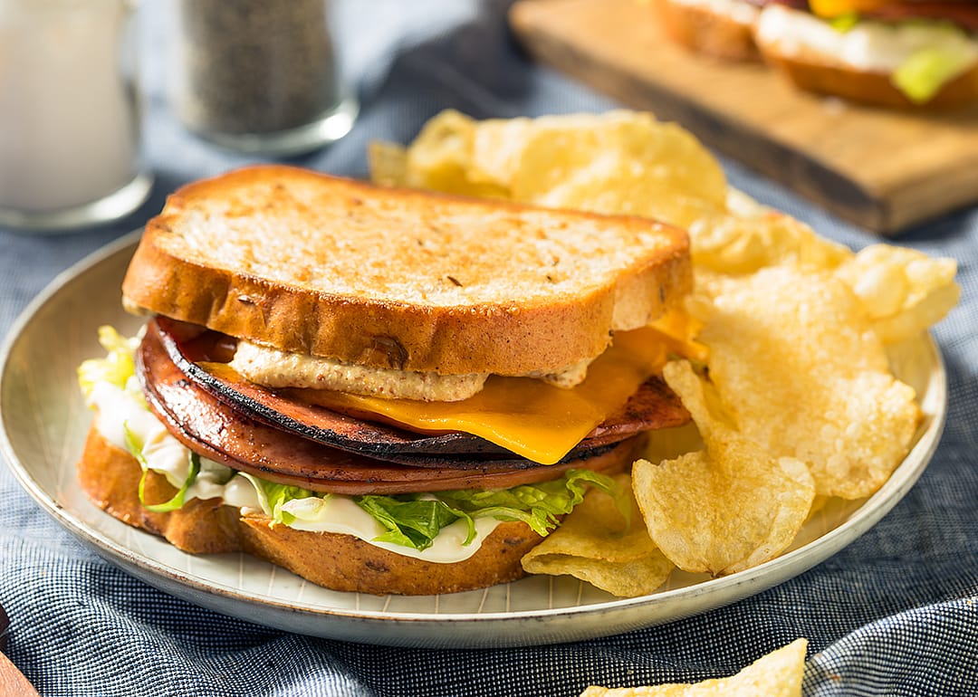 Fried bologna sandwich with cheese and lettuce.