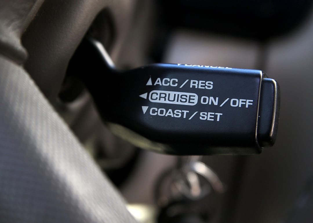 Close up on cruise control switch in car