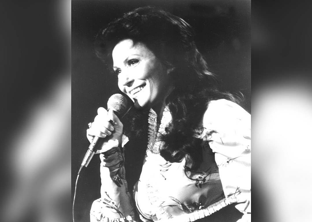 Loretta Lynn performing onstage.