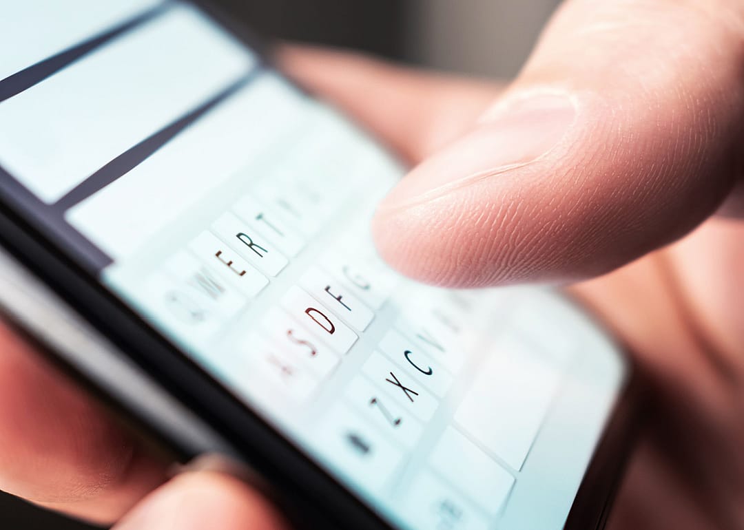 Person composing text message on phone.