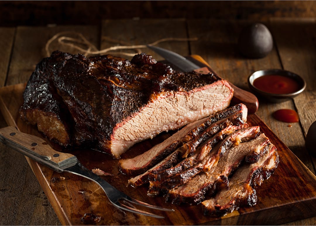 Brisket on a wooden cutting board.