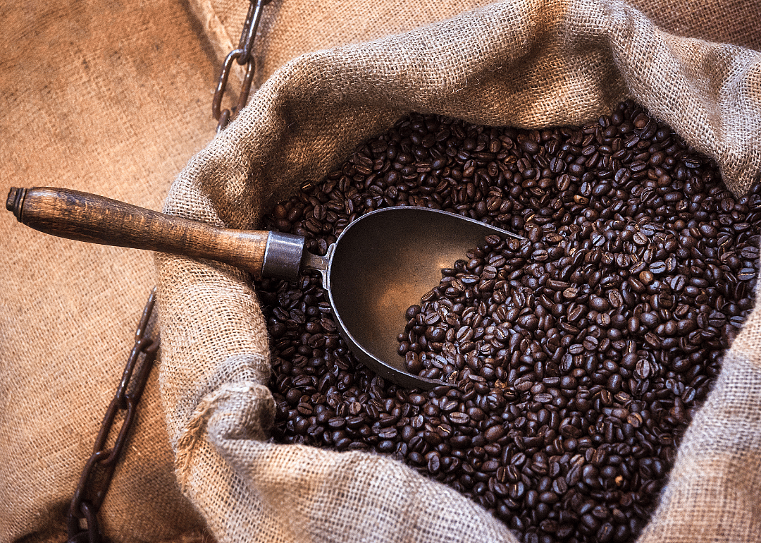 Roasted coffee beans in burlap sack.
