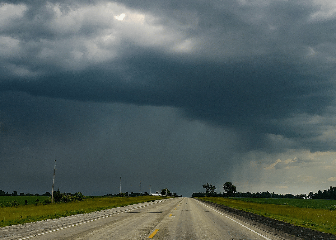 Storm cloud over rural landscape.