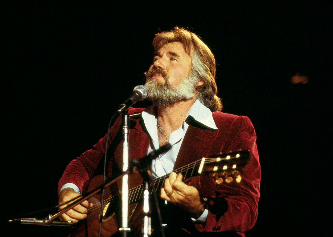Kenny Rogers performing onstage.