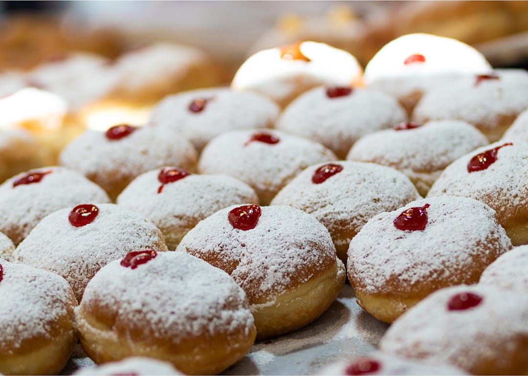 A close up of a batch of sufganiyot.