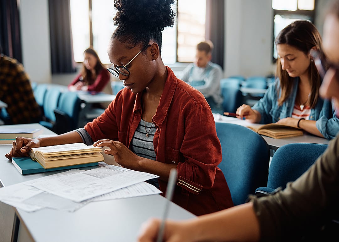 University student learning in lecture hall.