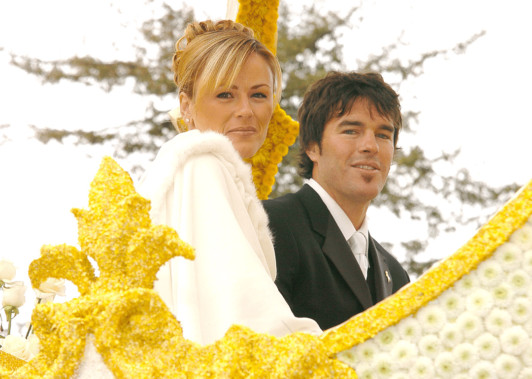 Trista Rehn and Ryan Sutter ride on float in parade.