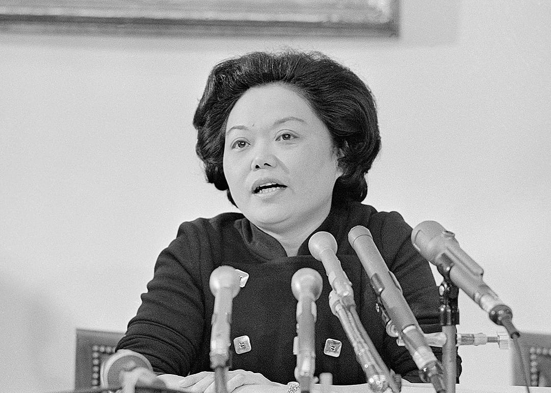 Patsy Mink speaking at microphones.