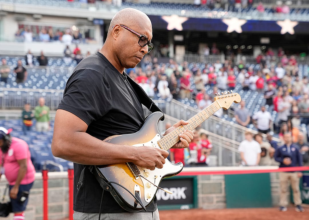 Bernie Williams plays the National Anthem on his guitar before a baseball game at Nationals Park.