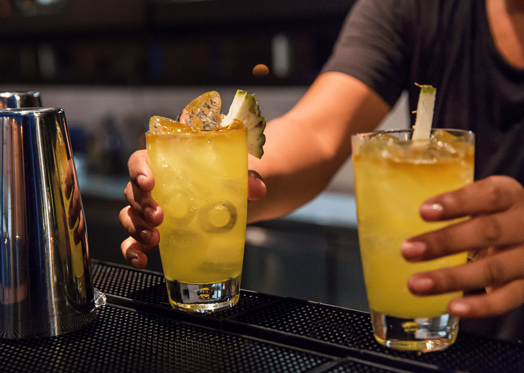 Bartender serving buy-one-get-one cocktails.