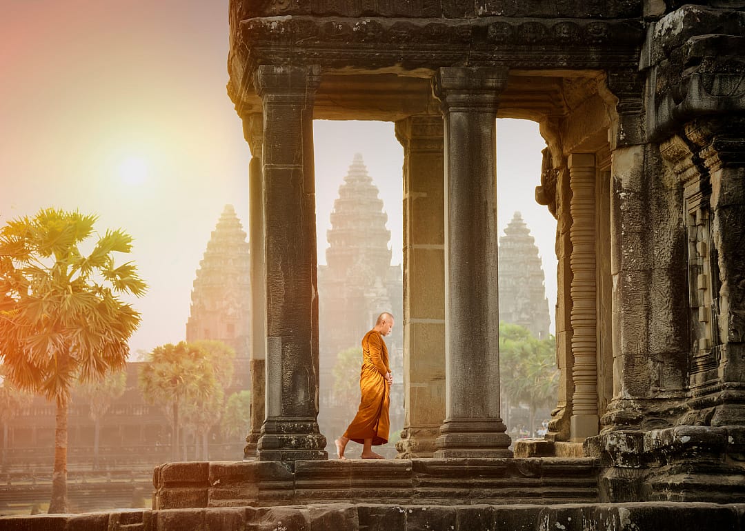 Monk walking in temple landscape at Angkor Wat.