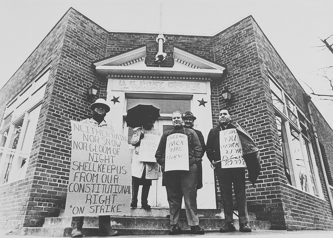 Striking postal workers with picket signs