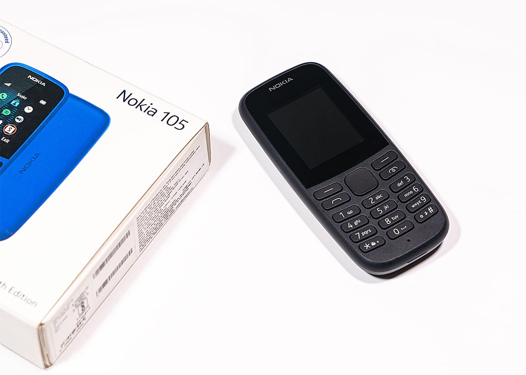 Nokia 105 phone and packaging on white background.