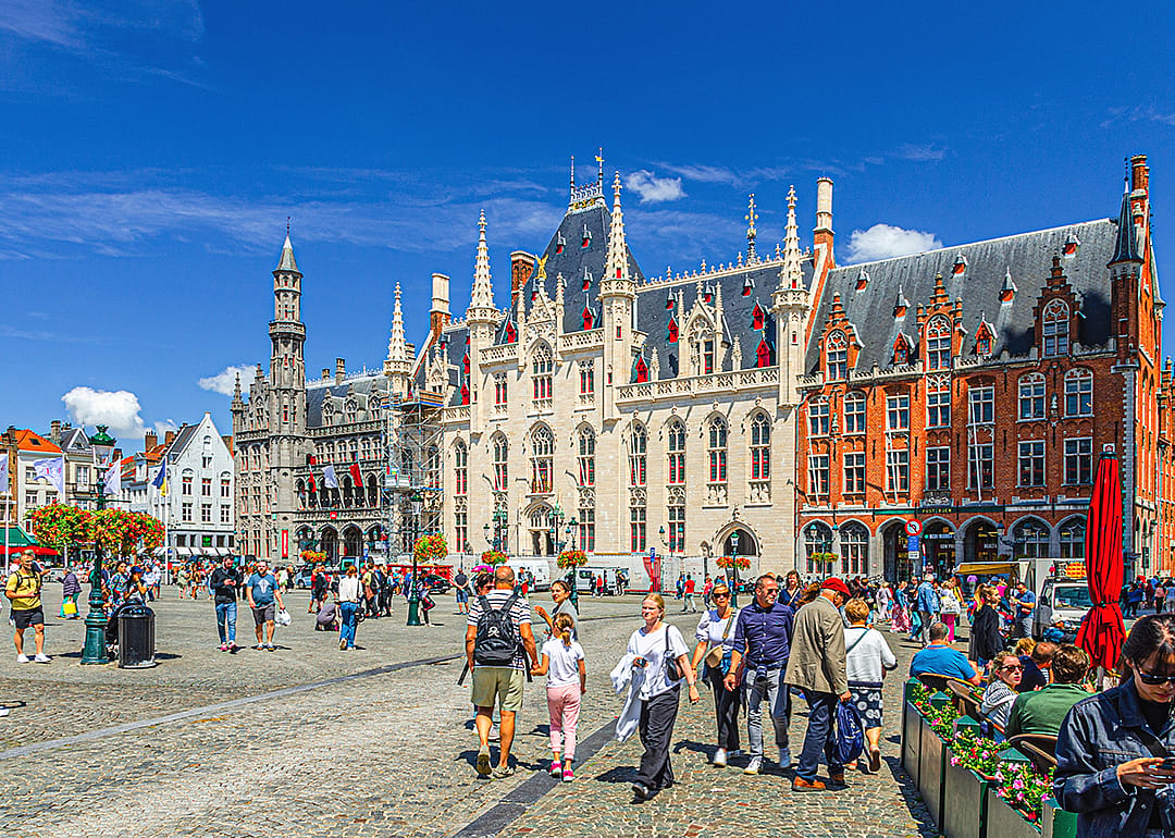Tourists walking down Market square in Bruges.