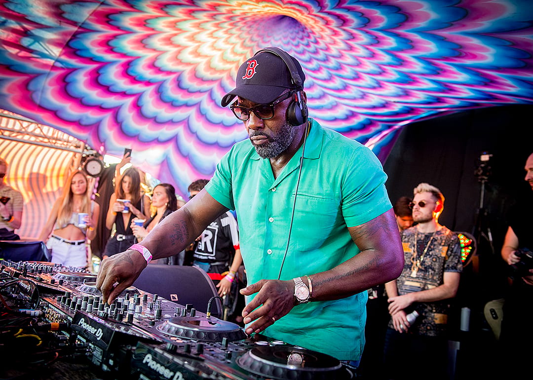 Idris Elba performs on stage.