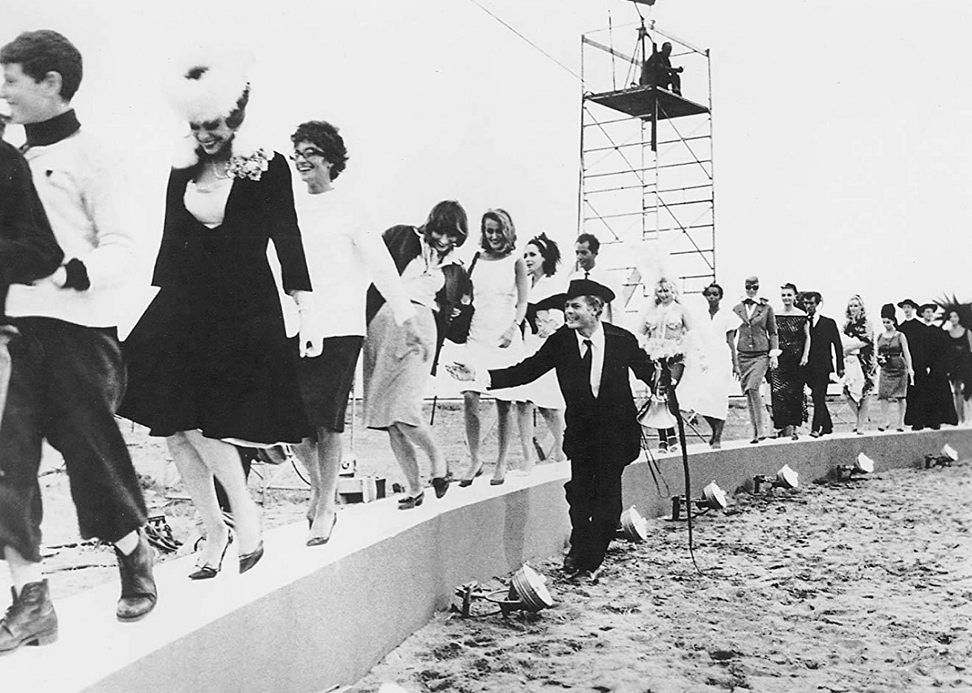 Marcello Mastroianni, Anouk Aimee and cast in a scene from ‘8 1/2’