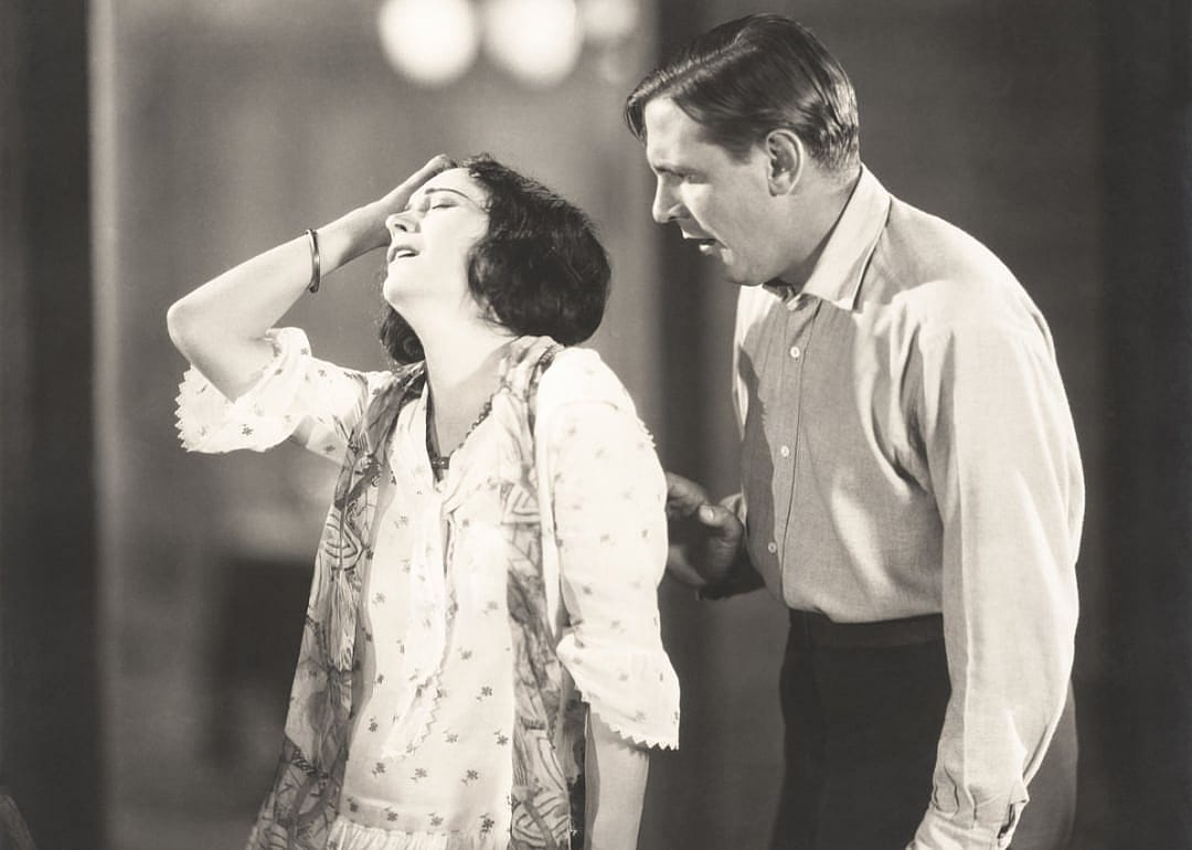 Vintage theatrical image woman with hand on head.