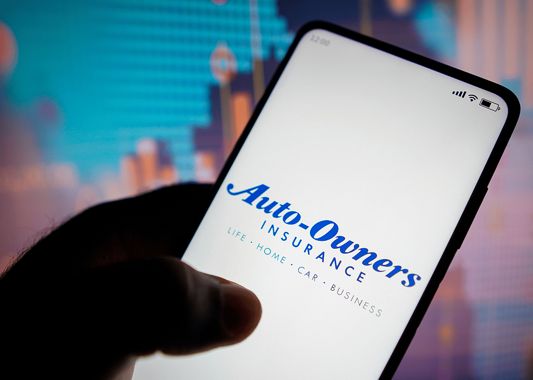 Auto-Owners Insurance logo on phone.