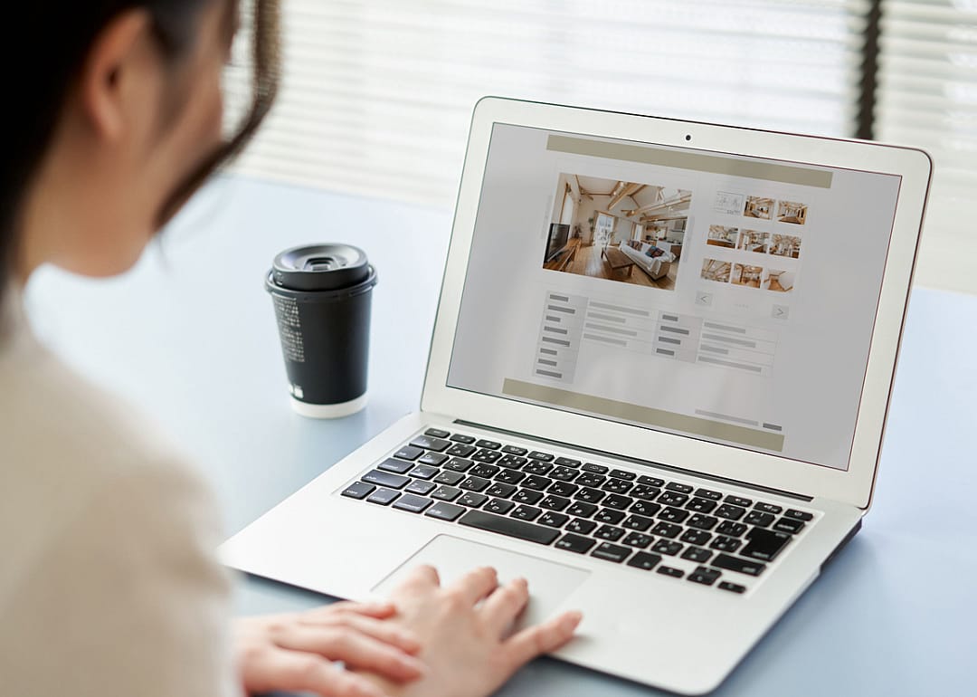 Person looking at apartment listing on laptop.
