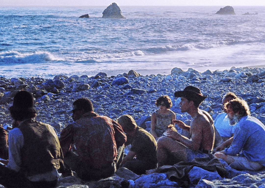 Hippies gathering at sunset on the beach.