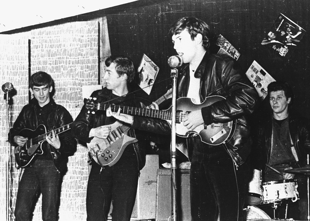 The Beatles perform in a club.