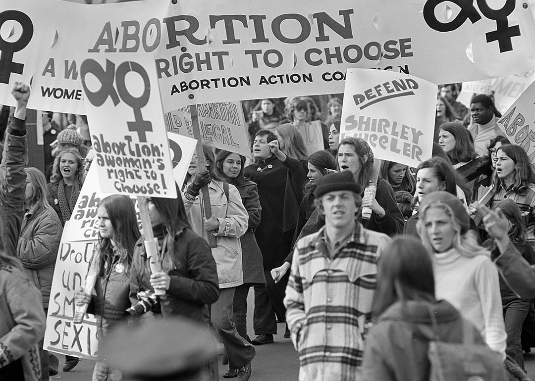 Pro-Choice demonstrators with signs march on Pennsylvania Avenue.