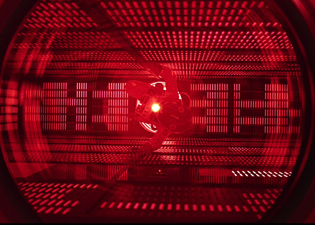 Actor Keir Dullea floating in a surreal, futuristic, red setting