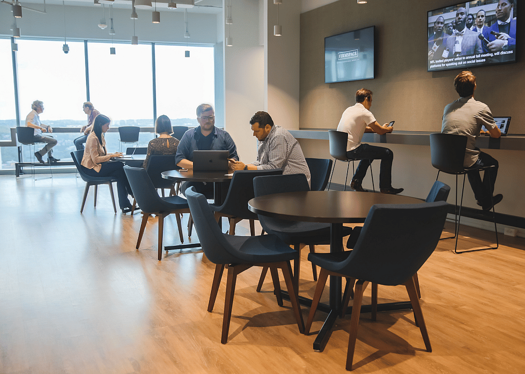 A group of employees working in an open office space