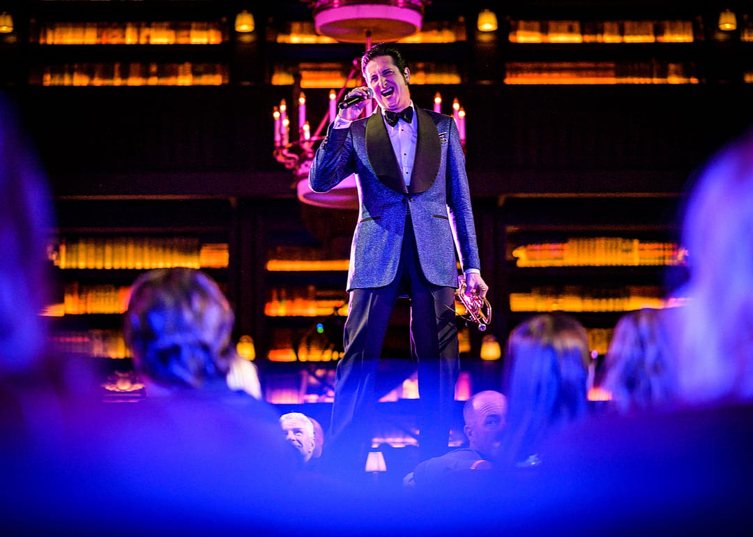 A male singer performs on stage.