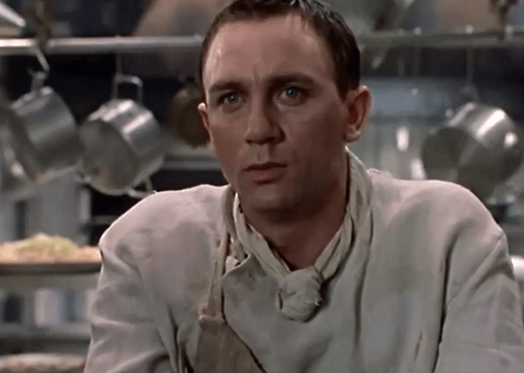 Daniel Craig dressed as a chef in a hotel kitchen