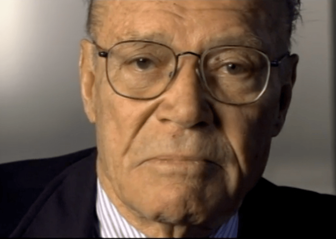 Robert McNamara looking directly into the camera.
