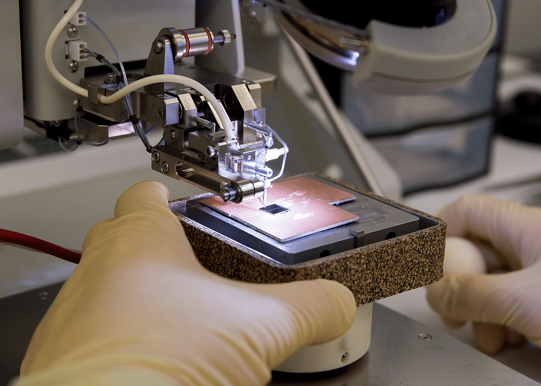 A silicon semiconductor chip being wirebonded.
