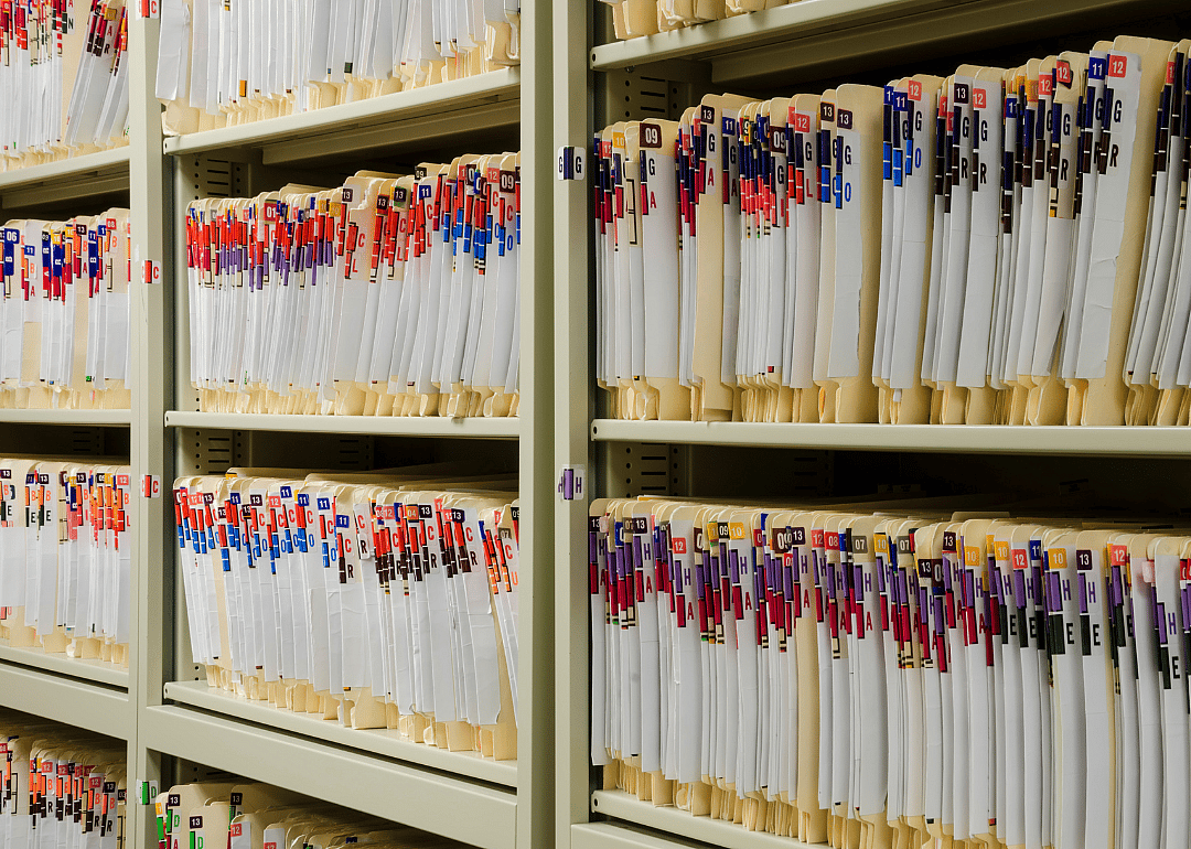 Medical files on shelves in storage.