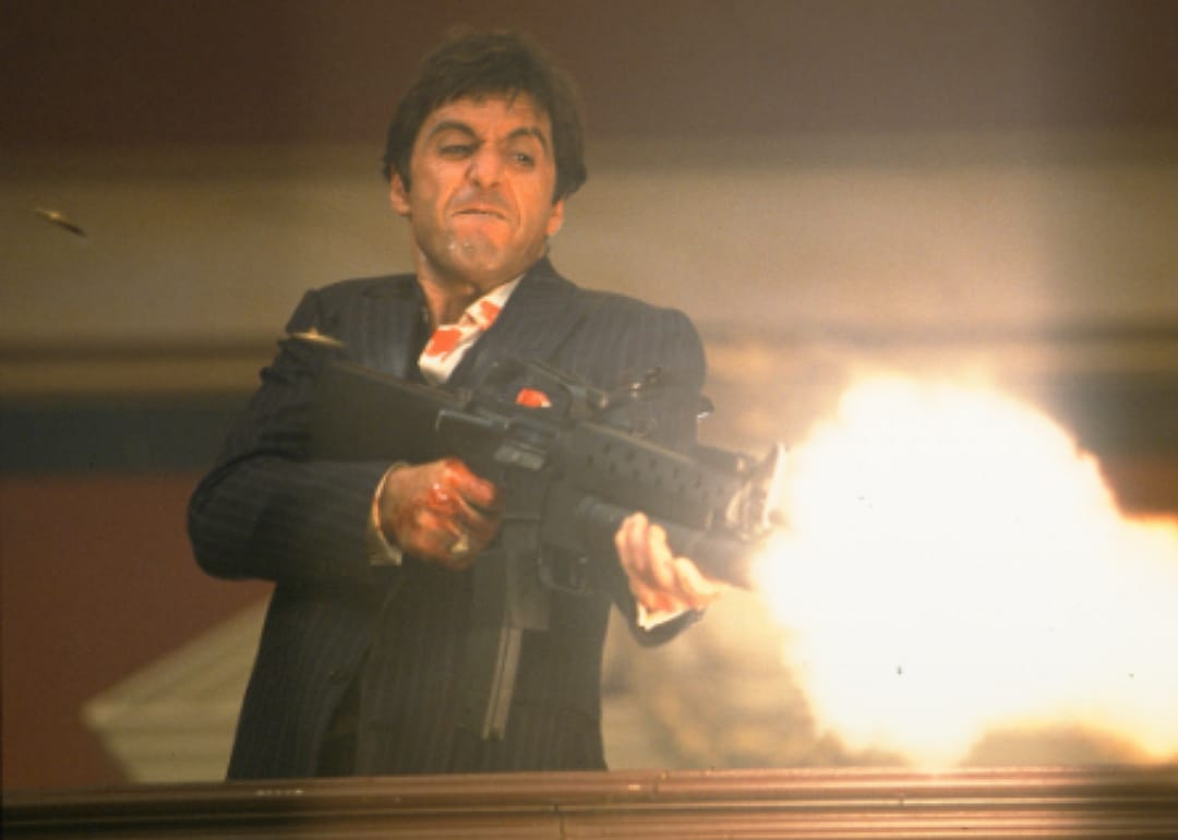 Al Pacino firing an assault rifle.