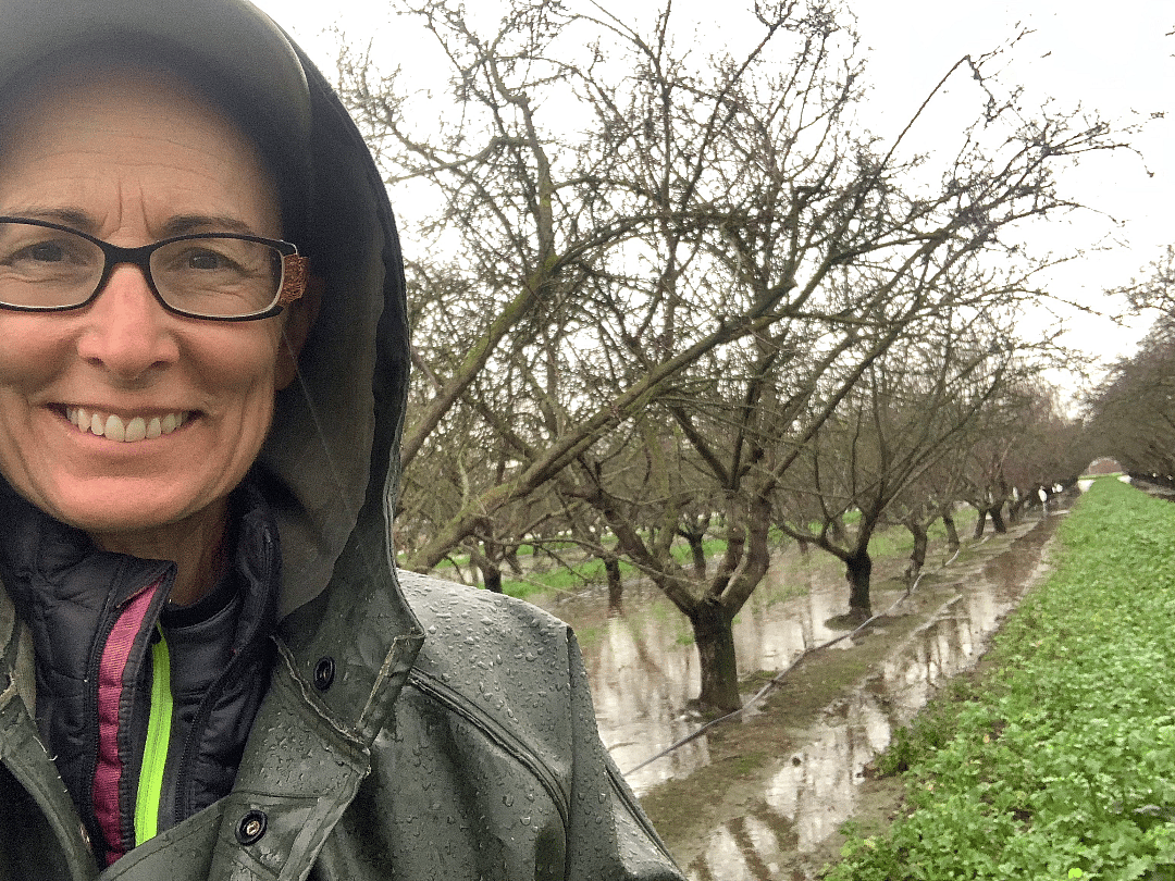 Christine Gemperle with her flooded almond farm during the rains of 2023