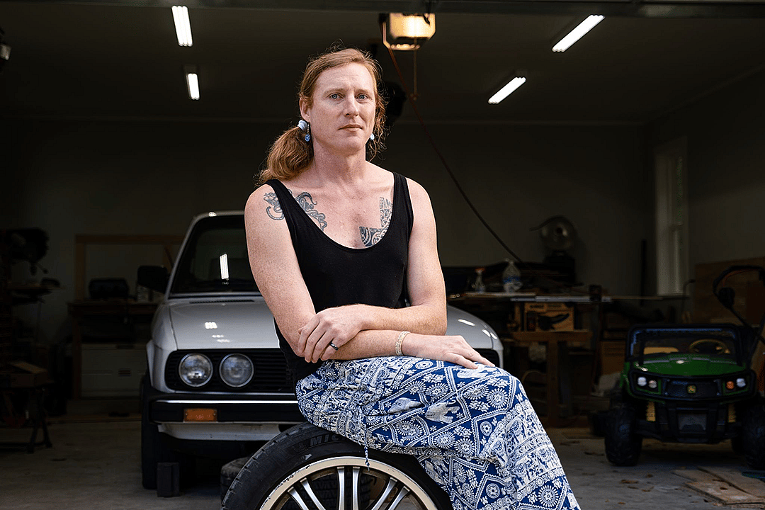 Anna Ray sits in front of her garage and her 1988 BMW E28 535i.