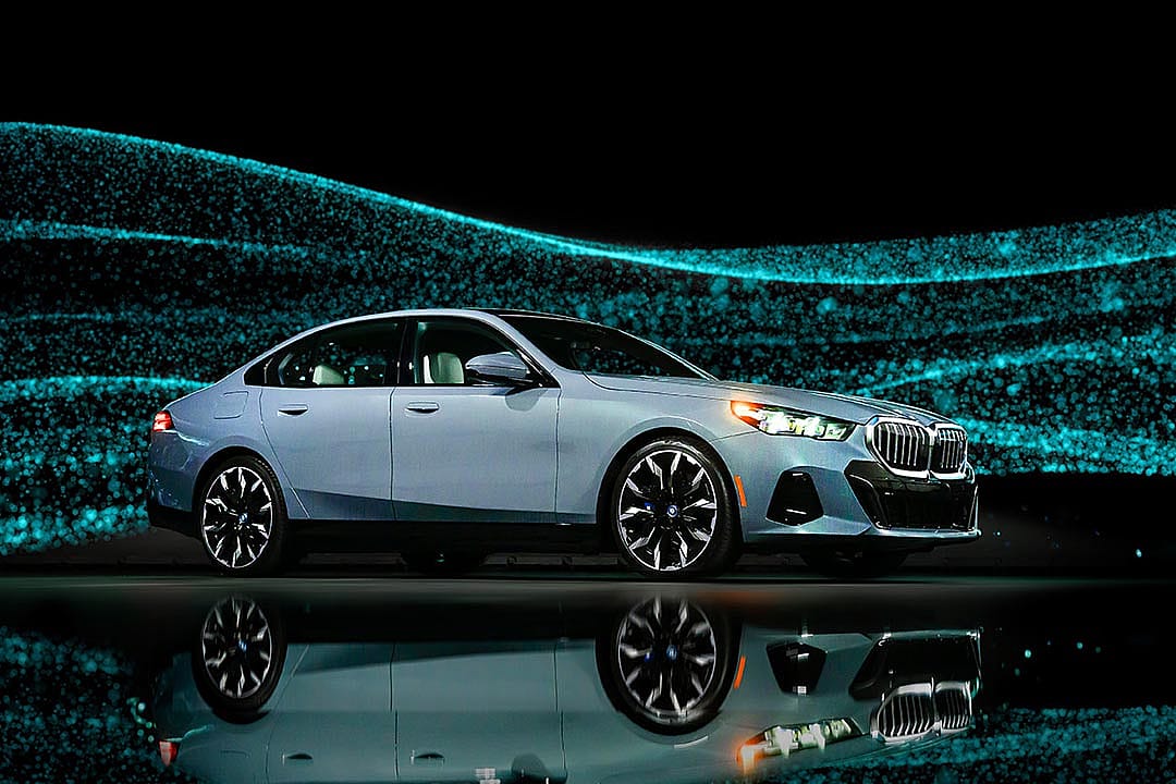 light blue BMWi5 against sparkly background
