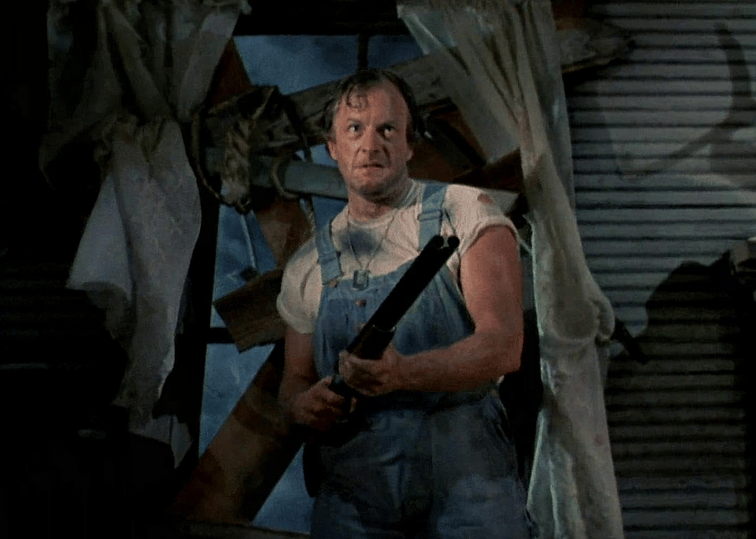 Dan Hicks holding a shotgun in a scene from "Evil Dead II" (1987)