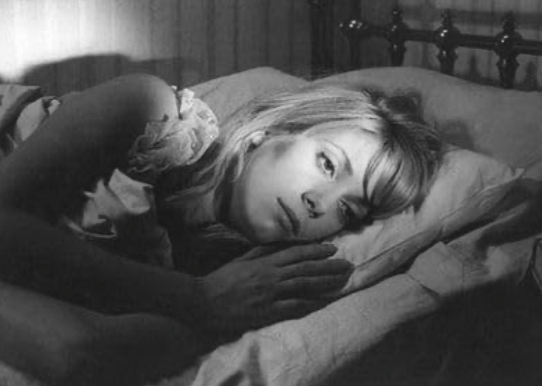 Actor Catherine Deneuve lying awake on her pillow in a scene from "Repulsion"