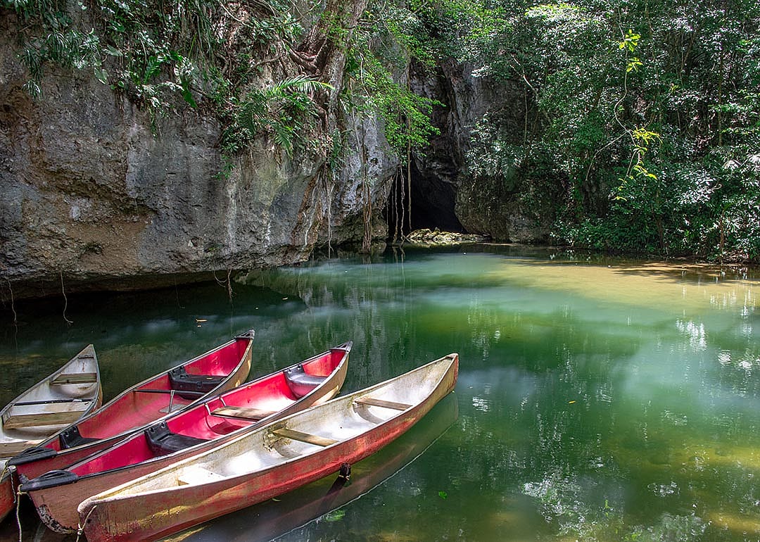 Canoes at the entrance to Barton Creek Cave in the Cayo District of Belize, Central America.