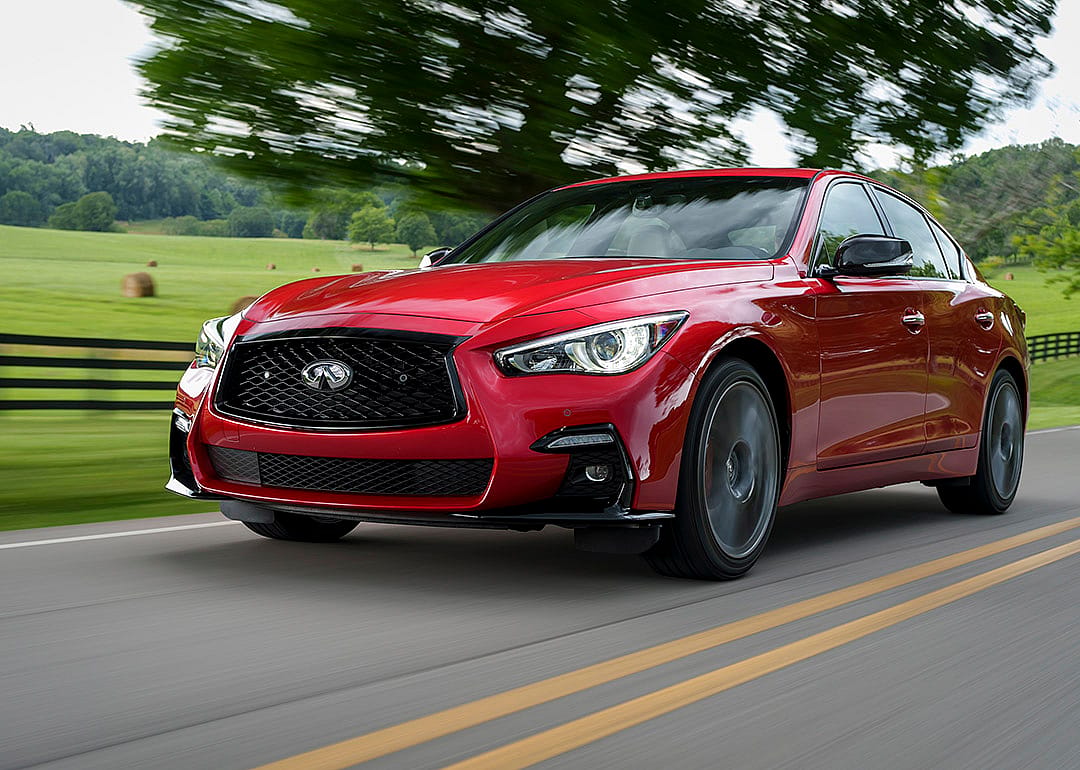 A red Infiniti Q50 on the road.